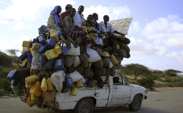 Residents ride on a pick-up truck that supplies milk and other items in Somalia's capital Mogadishu